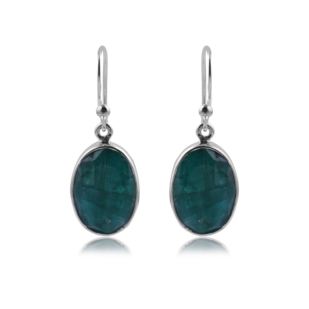 A pair of elegant Simple Silver & Rough Emerald Oval Earrings by Watermelon Tropical with oval-shaped green gemstones set in sterling silver. These earrings feature a simple hook design for easy wearing and a minimalist, contemporary look.