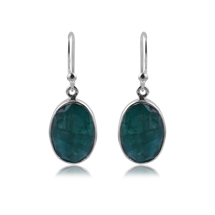 A pair of elegant Simple Silver & Rough Emerald Oval Earrings by Watermelon Tropical with oval-shaped green gemstones set in sterling silver. These earrings feature a simple hook design for easy wearing and a minimalist, contemporary look.