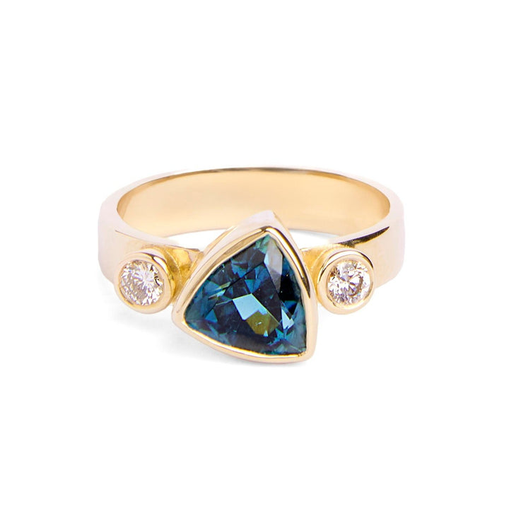 9ct yellow gold ring with triangular blue tourmaline in the centre and round diamond on either side set in 9ct yellow gold 9ct yellow gold band is 4 mm wide