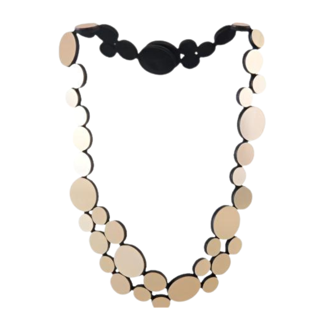 The Abstraction Fizz Gold Necklace by Iskin Sisters features variously sized, round, gold-colored discs on a black base for a modern statement look.