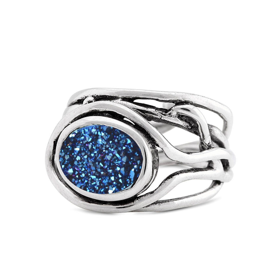 Gallardo & Blaine Designs' Adjustable Fossil Ring showcases an intricate sterling silver band with a shimmering blue druzy center.