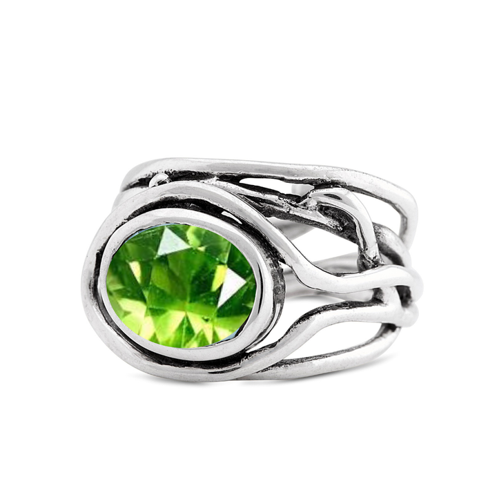 Gallardo & Blaine Designs' Adjustable Fossil Ring in silver boasts an abstract, twisted band with a large, oval-shaped green gemstone, making it a true statement piece.