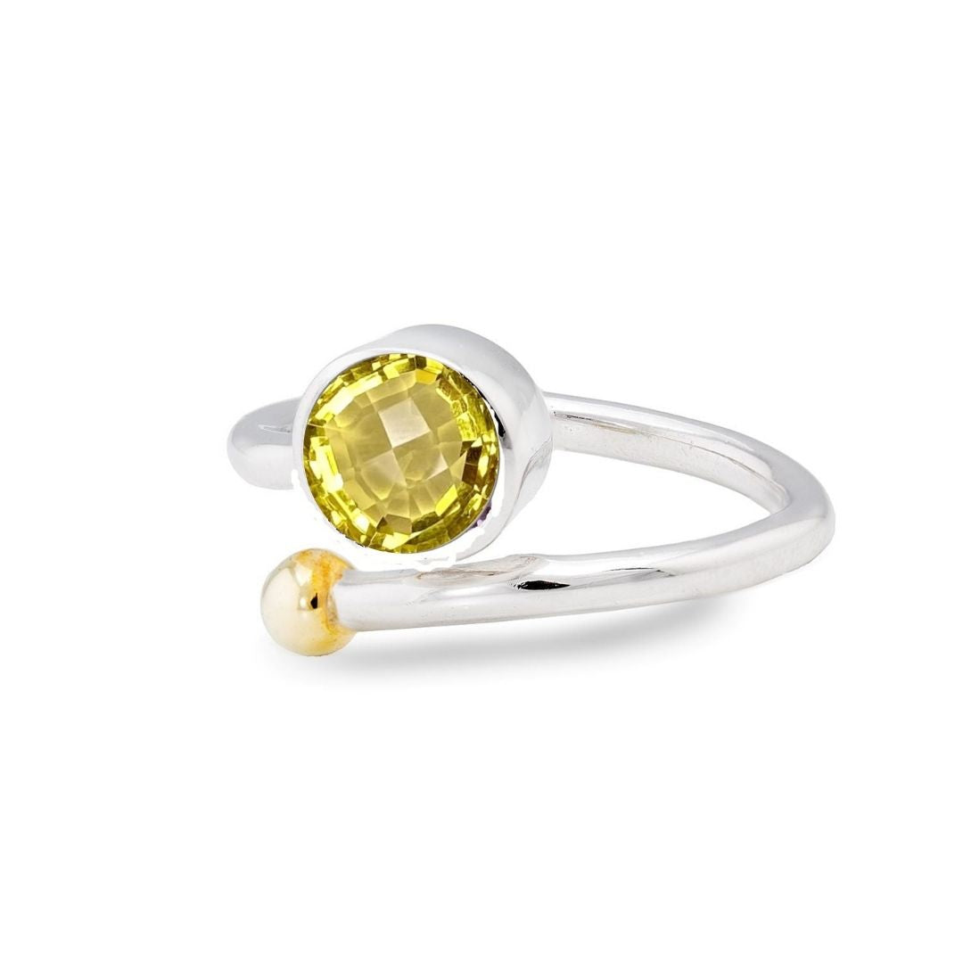 The Adjustable Honeysuckle Ring by Gallardo & Blaine Designs features an open design in silver gold with a round yellow gemstone and a small bead, elegantly curving around the finger. This comfortable, adjustable ring captures nature's charm in every detail.