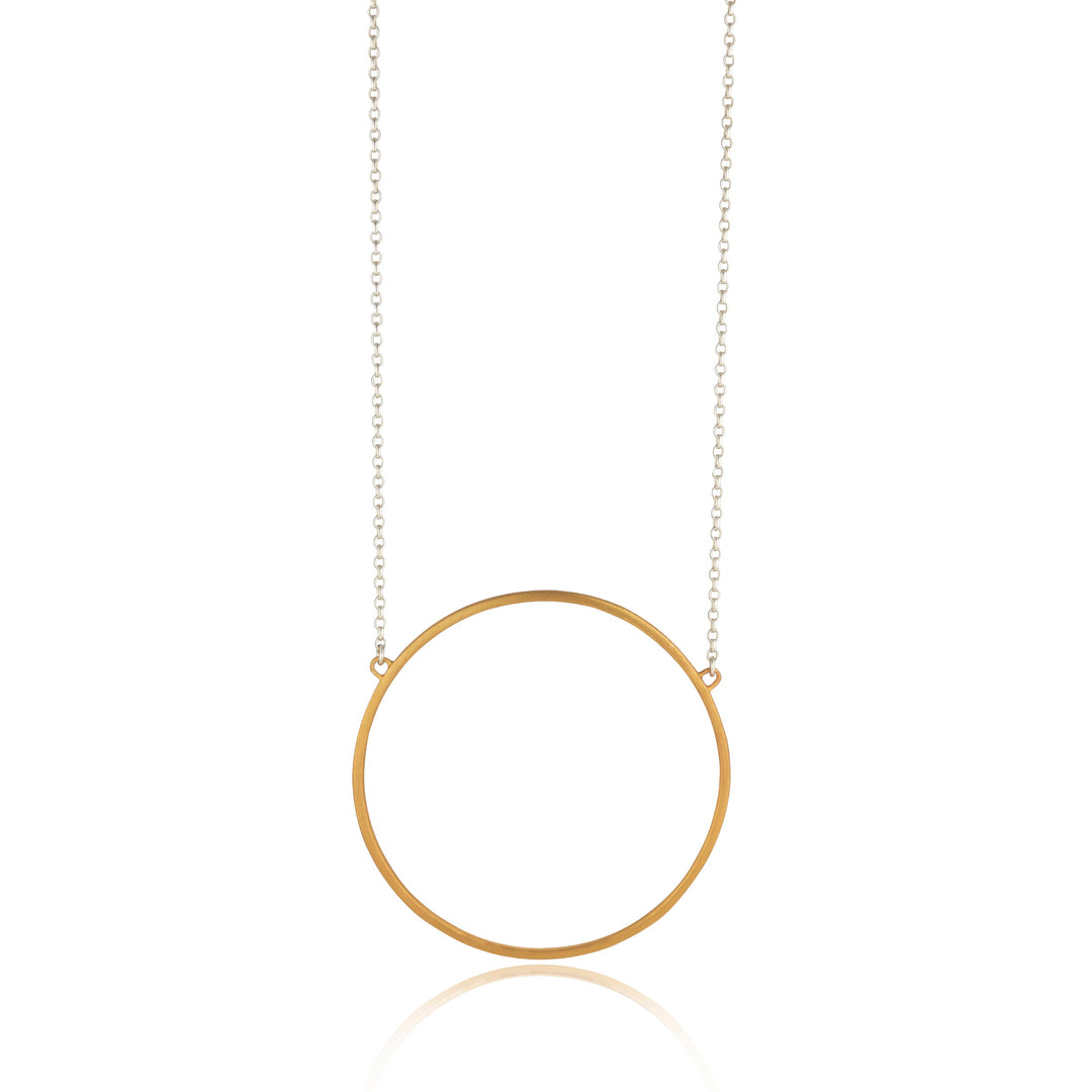 The Ancaire Yellow Gold Vermeil Neckpiece by Lynsey de Burca features a thin circular pendant. The pendant is suspended from a fine chain that is anchored at the top of the circle, creating a minimalist yet elegant design, perfect for those who appreciate unique jewelry.