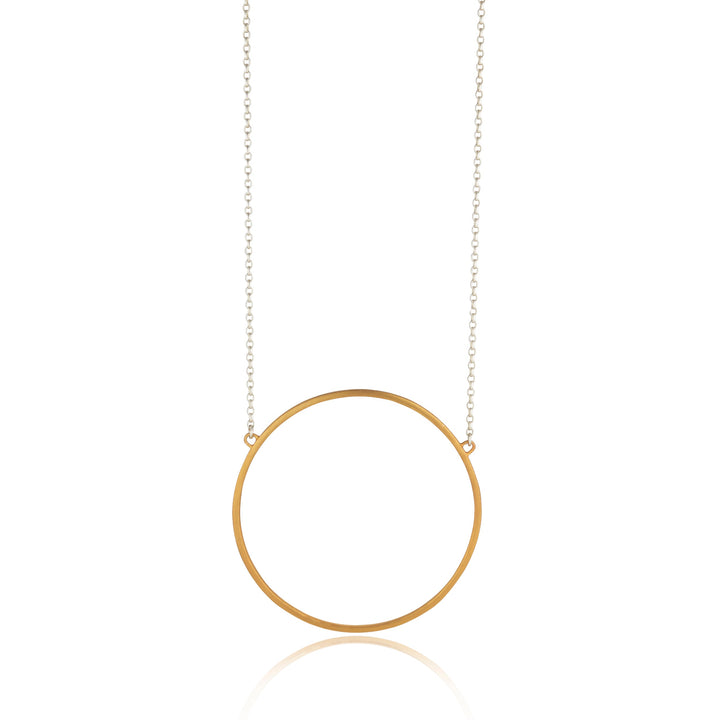 The Ancaire Yellow Gold Vermeil Neckpiece by Lynsey de Burca features a thin circular pendant. The pendant is suspended from a fine chain that is anchored at the top of the circle, creating a minimalist yet elegant design, perfect for those who appreciate unique jewelry.