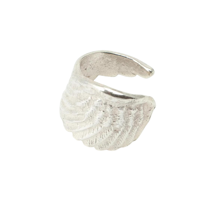 The Jennifer Kinnear Angel Wing Ring, available in silver or gold, features detailed etching and an open design for adjustable fit—perfect for those who love the elegance of textured angel wings.