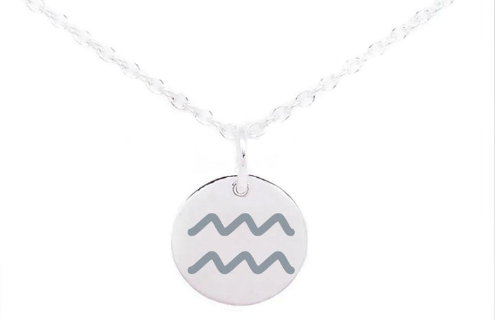 A Horoscope Large Disc Charm Silver from Personalised Charms with a round pendant featuring the Aquarius zodiac sign symbol, represented by two horizontal wavy lines. The background is plain white, making it a timeless piece that perfectly encapsulates horoscope symbols and sophisticated charm.