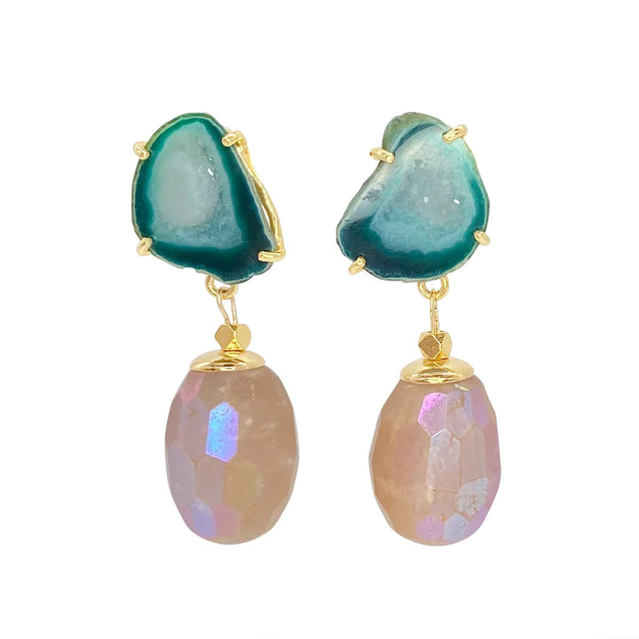 The Aria Earrings by Aria V feature asymmetrical teal geode stones on top and iridescent faceted peach beads hanging below, connected by gold plated brass wire.