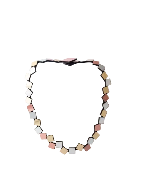 A necklace featuring small, irregular geometric squares in silver, gold and copper tones on a plain white background.