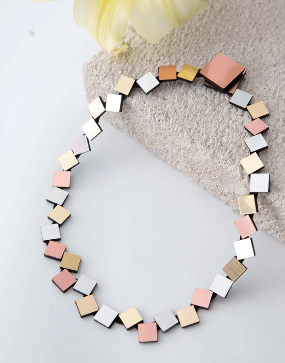 Iskin Sisters Bauhaus Round Squares Necklace - Silver, Gold & Copper, a handmade necklace composed of small, connected square tiles in alternating silver, gold, and copper metallic finishes.