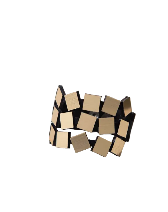 A geometric wide band bracelet featuring square tiles of brushed gold, displayed on a white background.