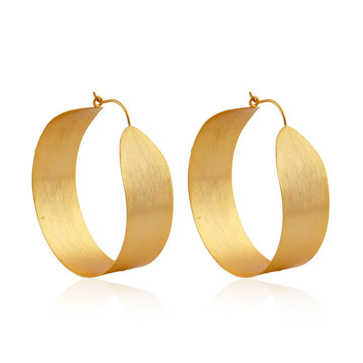 A pair of thick gold plate hoop earrings with a wide, curved design and a brushed finish. The Betty Gold Hoops by Watermelon Tropical feature a clasp closure at the top and are photographed against a white background.