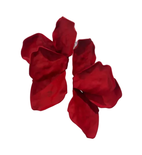 Two large, deep red petals are set against white, echoing the abstract, floral-inspired Bougainvillea Earrings in various colours by Kybalion Jewellery—a bold statement with delicate shadow play.
