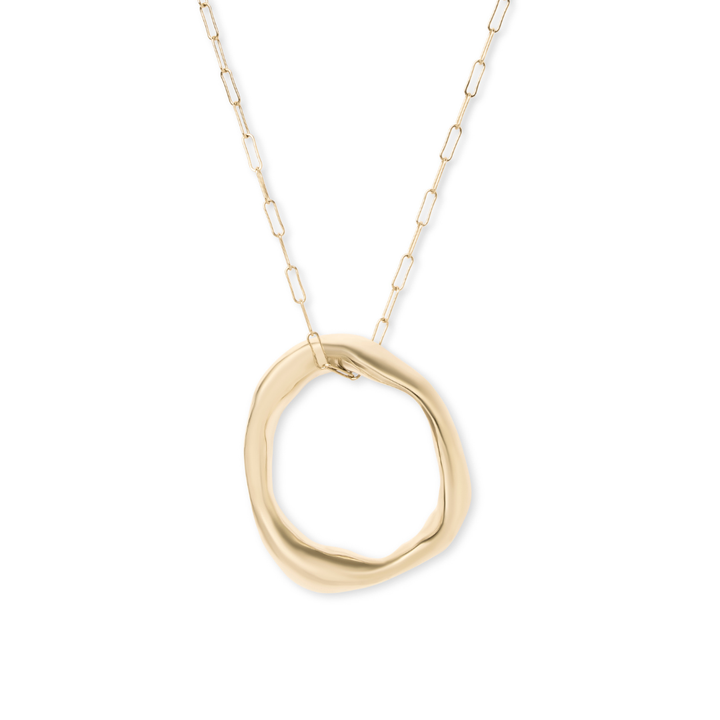 The Bough Necklace by Madeleine Sculptural Jewellery features a delicate gold chain and a large, smooth, organically shaped circular pendant—an elegant piece of organic jewellery.