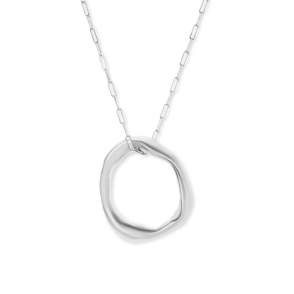 The Bough Necklace by Madeleine Sculptural Jewellery features a delicate silver chain with a circular, organically-shaped pendant and smooth, wavy surface, capturing modern minimalism and the beauty of organic jewellery.