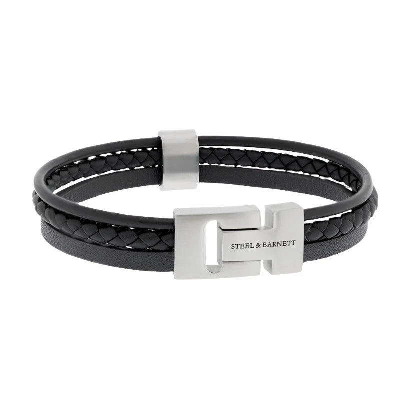 The Cole - Black bracelet by Steel and Barnett combines braided and smooth textures of black genuine leather, highlighted by a stainless steel clasp engraved with "STEEL & BARNETT." This sleek, modern design lies flat on a neutral background.