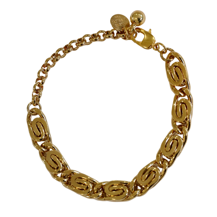 The Caesar Chain Gold Plated Scroll Chunky Bracelet by Zubeldia features oval links with an engraved “S” pattern, a lobster clasp, and small round charms near the closure.
