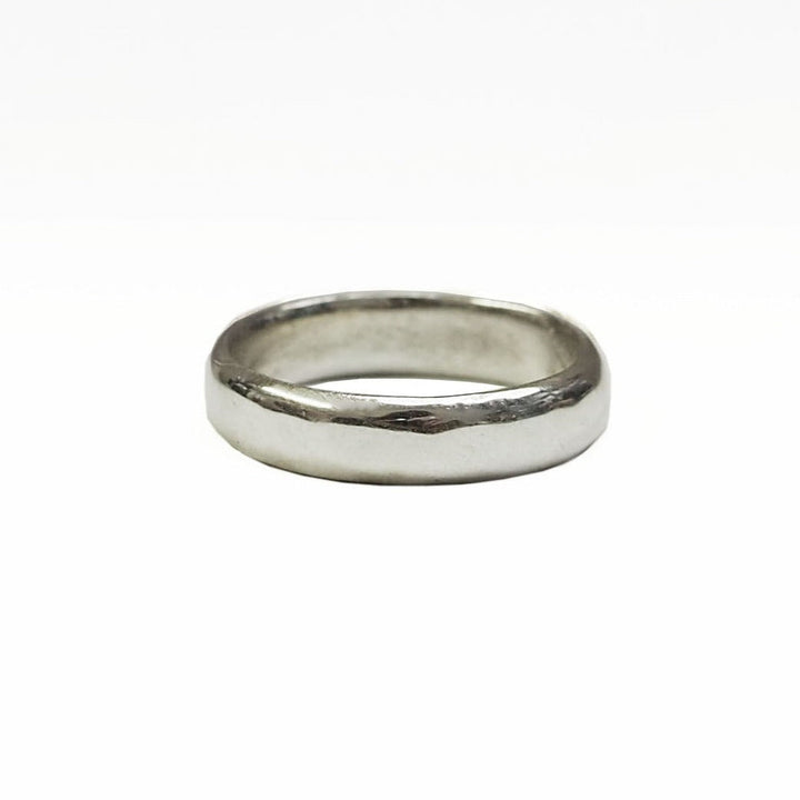 A simple, plain silver ring with a smooth, polished surface shown against a white background. The Classic 4mm Wedding Band by The Collective Dublin is uniform in width, giving it a clean and classic appearance reminiscent of classic wedding rings.