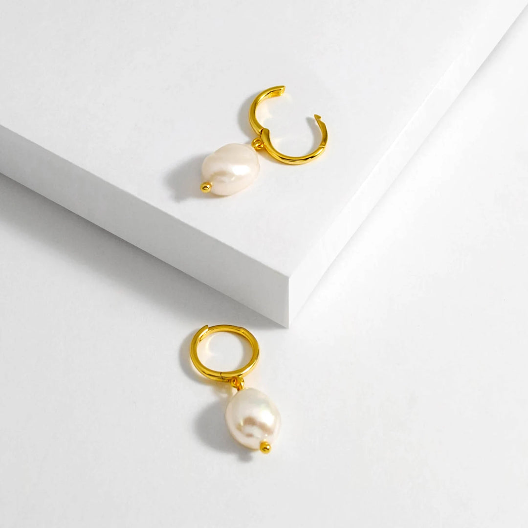 Huggie hoop earrings with pearl charm in gold plate silver