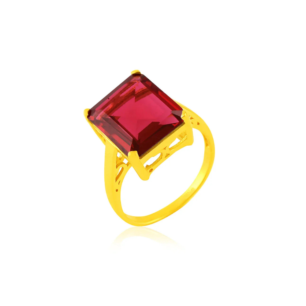 The Claudia Ring by Shyla is a vintage gold-on-sterling silver statement ring with a large square-cut red gemstone set in an ornate openwork band, shown on a white background.