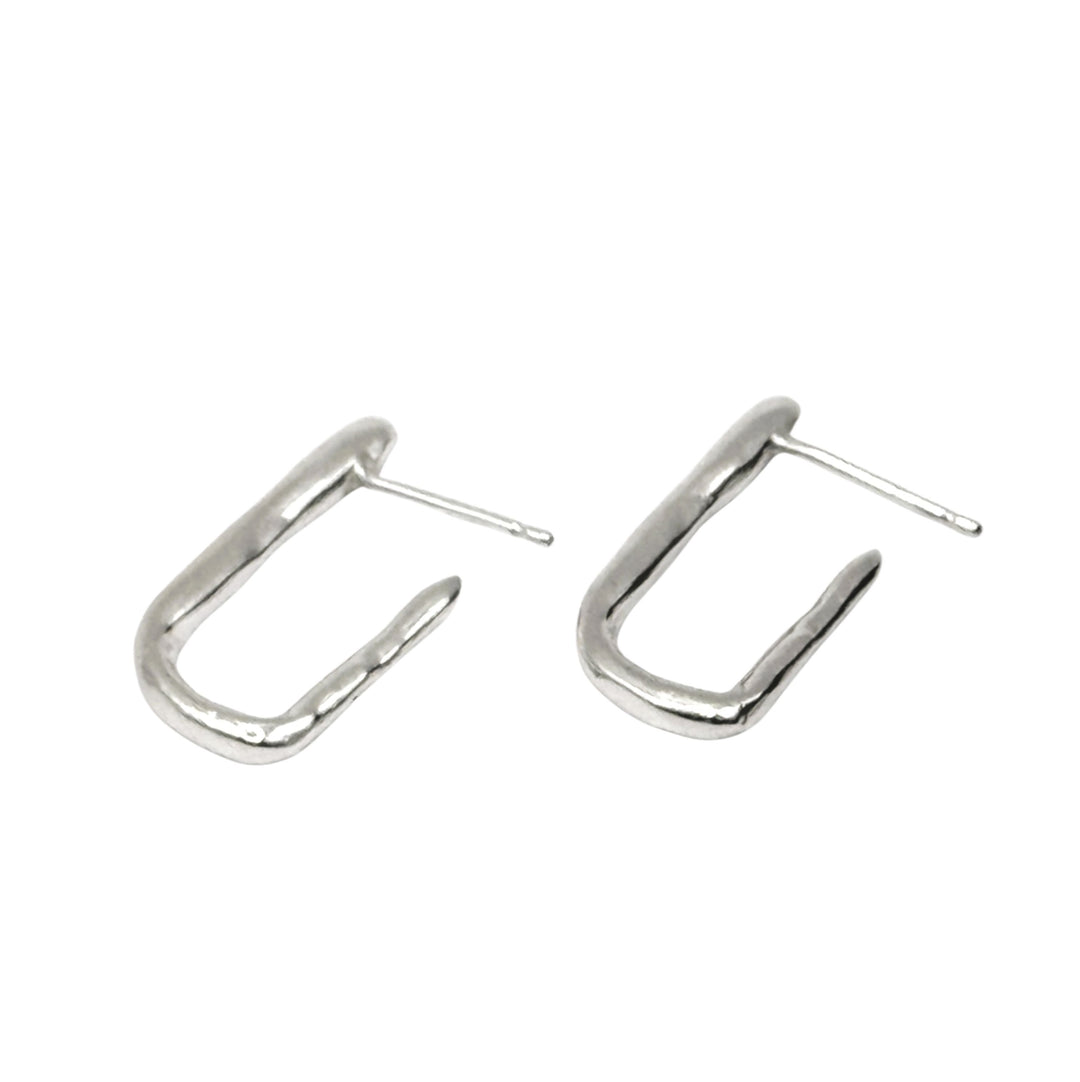 The Comfort Square Hoop Earrings by Inó Jewellery feature a minimalist, irregular open hoop design in sterling silver with straight posts, perfect for those who love simple style. Shown on a white background.