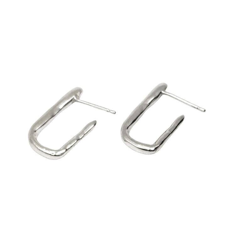 The Comfort Square Hoop Earrings by Inó Jewellery feature a minimalist, irregular open hoop design in sterling silver with straight posts, perfect for those who love simple style. Shown on a white background.