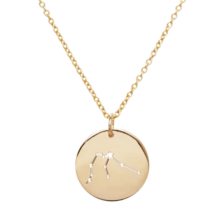The Constellation Necklace in 9k Gold by Personalised Charms features a round charm engraved with your star sign and sparkling stones marking the stars—a stunning piece of zodiac jewelry.
