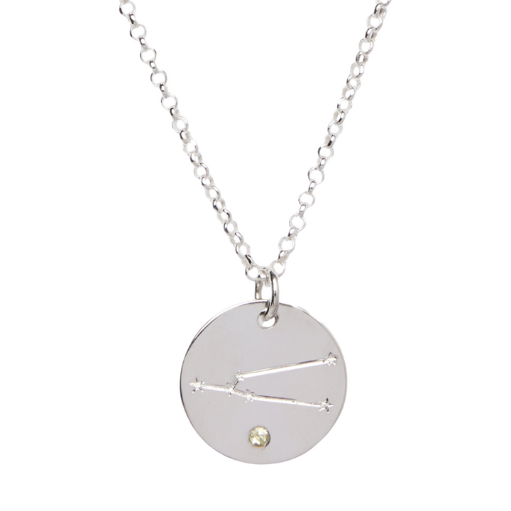 The Personalised Charms Constellation Symbol Pendant is a silver chain necklace with an engraved constellation design and a small gem accent near the bottom of the round charm.