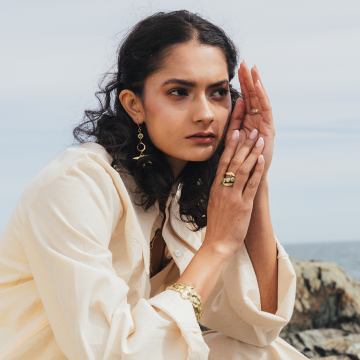 Moonwater Ring: hand-carved Dublin jewelry piece inspired by lunar energy and positive intention-setting. Crafted in brass, silver, gold-plated brass, or 9-carat gold. Stone options include Blue Topaz, Moissanite, Peridot, or Lab Grown Tourmaline. Each piece channels celestial inspiration into wearable luxury.
