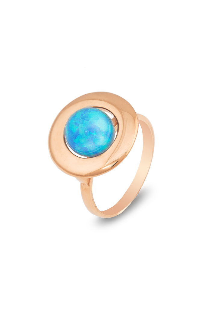 A Cosmic Boulevard Home Planet Blue Sky Opal 9ct Gold ring featuring a large, sky blue opal set at its center. The opal boasts a vibrant glow with varying shades of blue and green. The ring has a smooth, polished finish and a simple band design.