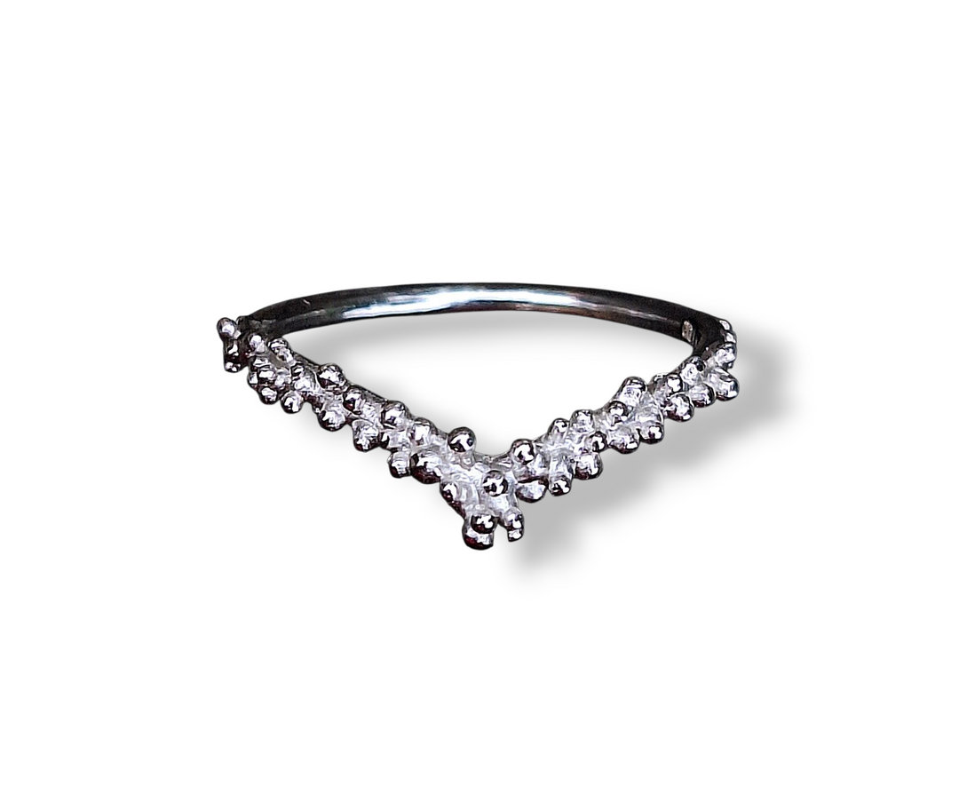 The Pale Raven Starborne Cosmic Wish Silver Ring features a sleek V-shaped design in polished silver, handcrafted for a subtle, cosmic-inspired look. Photographed on a white background with a soft shadow. No stones included.