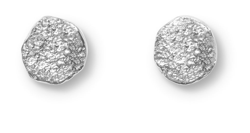 A pair of small, irregular sterling silver earrings with a textured finish, the Dublin Bay Silver Studs by Ava Jane Jewellery are handmade and displayed on a white background.