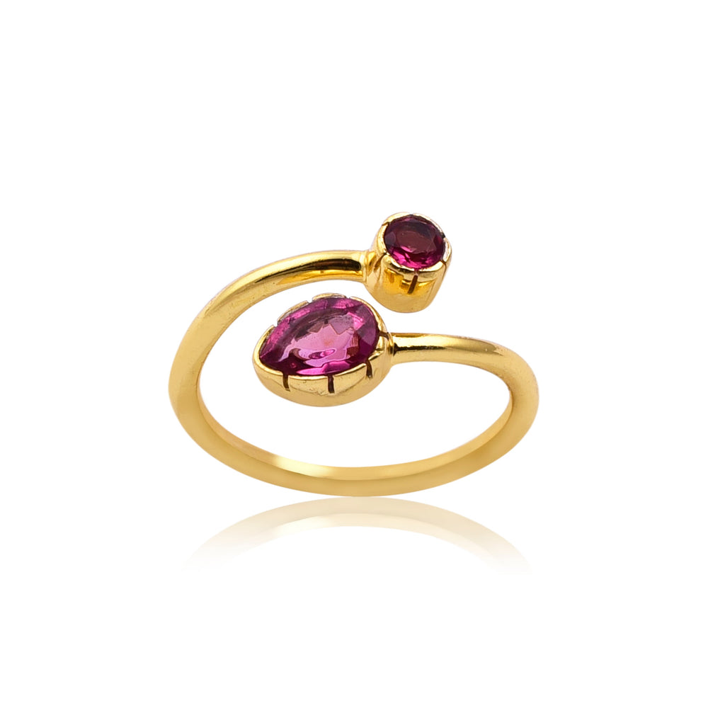 The Pink Quartz Gold Snake Ring by Watermelon Tropical features an open, adjustable band with two vibrant pink quartz gemstones. One stone is oval-shaped and larger, while the other is smaller and round. Both stones are set in simple, elegant gold settings, creating a modern and striking piece of handmade jewellery.