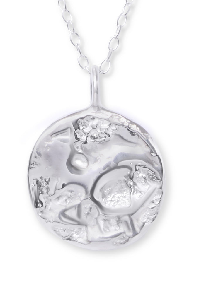 The Ava Jane Jewellery Dublin Bay Silver Pendant is a handmade sterling silver necklace with an abstract, textured circular design on a delicate chain.