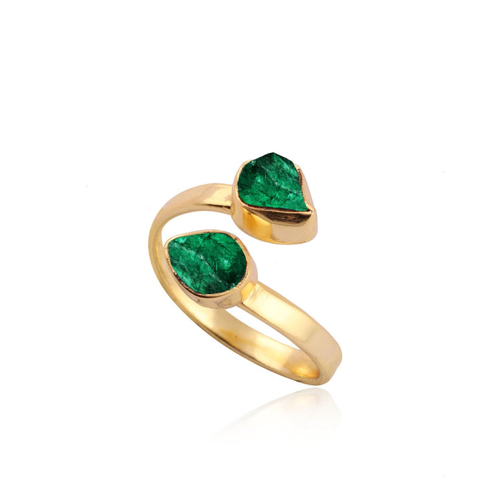 The Celia Gold Green Onyx Ring by Watermelon Tropical features a thick gold-plated band with an open design, showcasing two green onyx leaf-shaped stones set in an asymmetrical arrangement. The stones are mounted at each end of the band, creating a modern, elegant look against the white background.