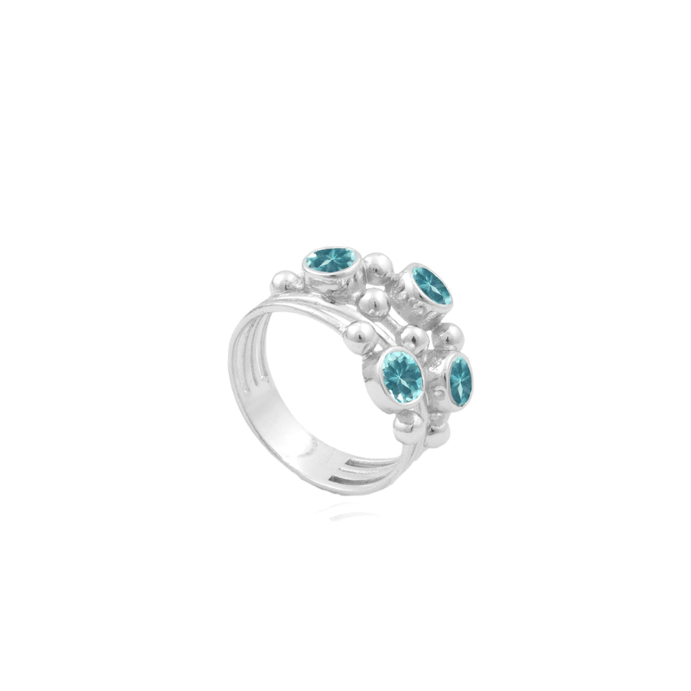 A silver ring featuring five circular Apatite baubles set in a clustered arrangement with raised silver bead detailing around each stone. The band is smooth and polished. This beautiful piece is the Justine Ring in Apatite by Watermelon tropical.