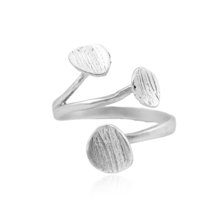 The Rachel Ring by Watermelon Tropical is a silver ring featuring an open design with three textured, leaf-shaped elements on top. The ring has a polished finish and a modern, artistic look, with each leaf arranged at different angles along the band. This Egyptian-inspired ring offers a touch of ancient elegance to contemporary style.