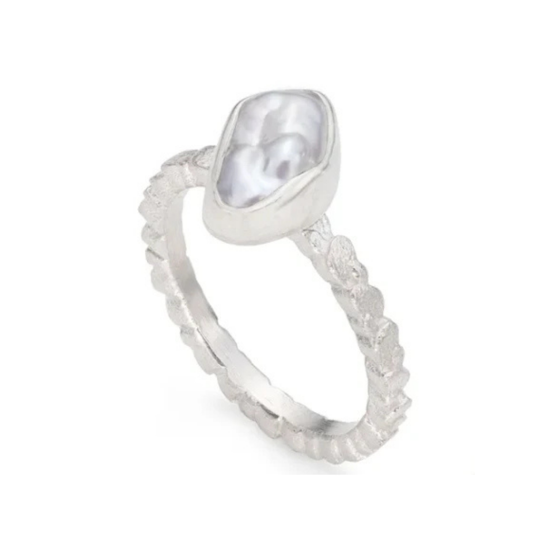 Silver ring with a textured band with a irregular baroque keshi pearl on a white background
