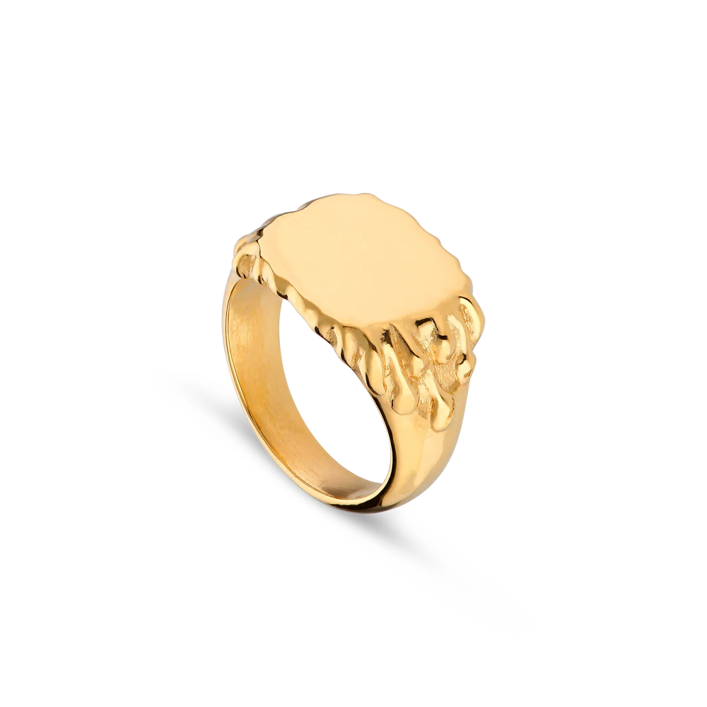 The Drippy Signet Ring from Jane Koenig features a gold-plated, oval-shaped face and a distinctive molten texture on the band and sides, shown against a plain white background.