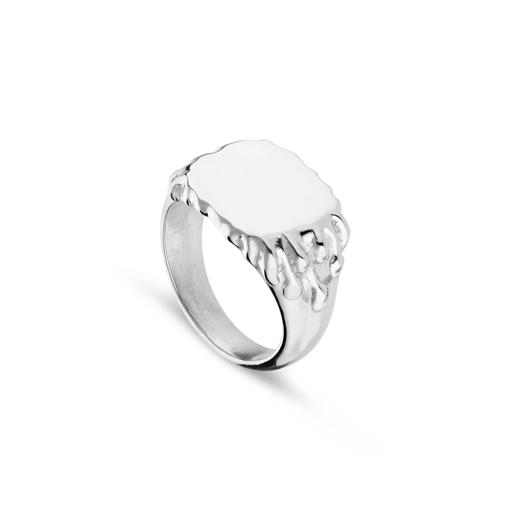The Jane Koenig Drippy Signet Ring is crafted in sterling silver, featuring a smooth oval face with melting, drip-like details along the edge, shown against a plain white background.
