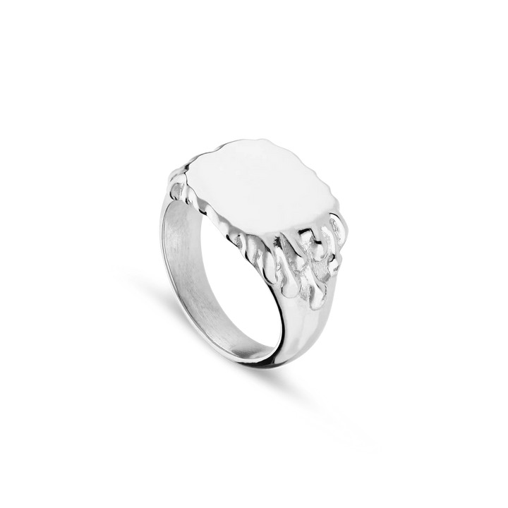 The Jane Koenig Drippy Signet Ring is crafted in sterling silver, featuring a smooth oval face with melting, drip-like details along the edge, shown against a plain white background.