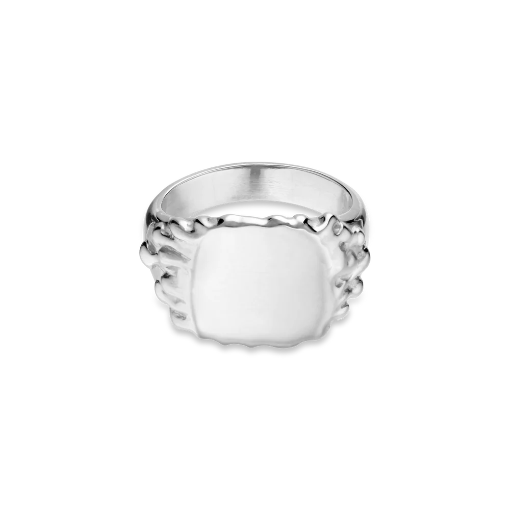 The Jane Koenig Drippy Signet Ring features a wide, polished sterling silver rectangular face with textured, organic-shaped edges, showcased on a plain white background—a modern update on the classic signet ring.