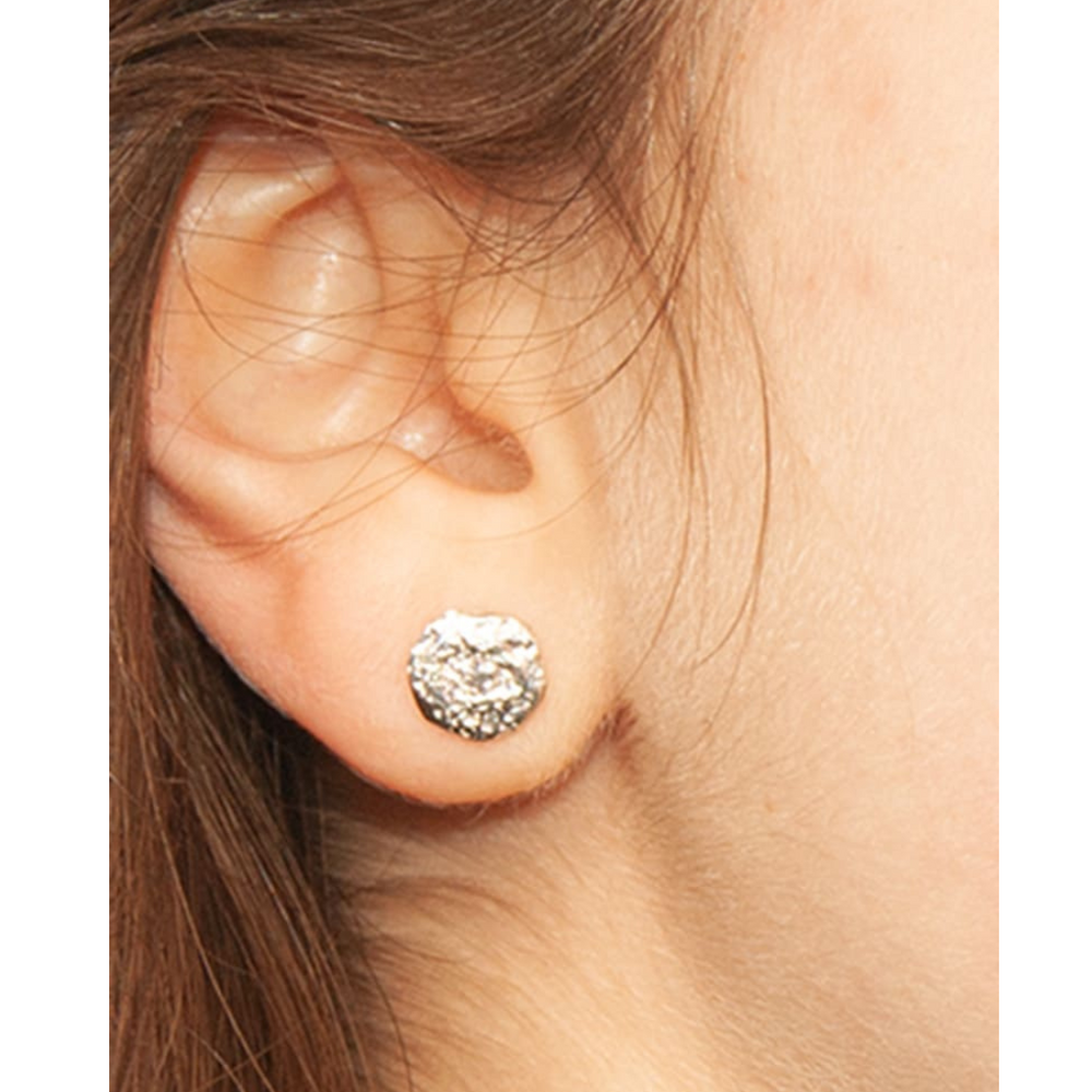 Close-up of a person's ear wearing Dublin Bay Silver Studs by Ava Jane Jewellery. Brown hair is partially visible on the left side.