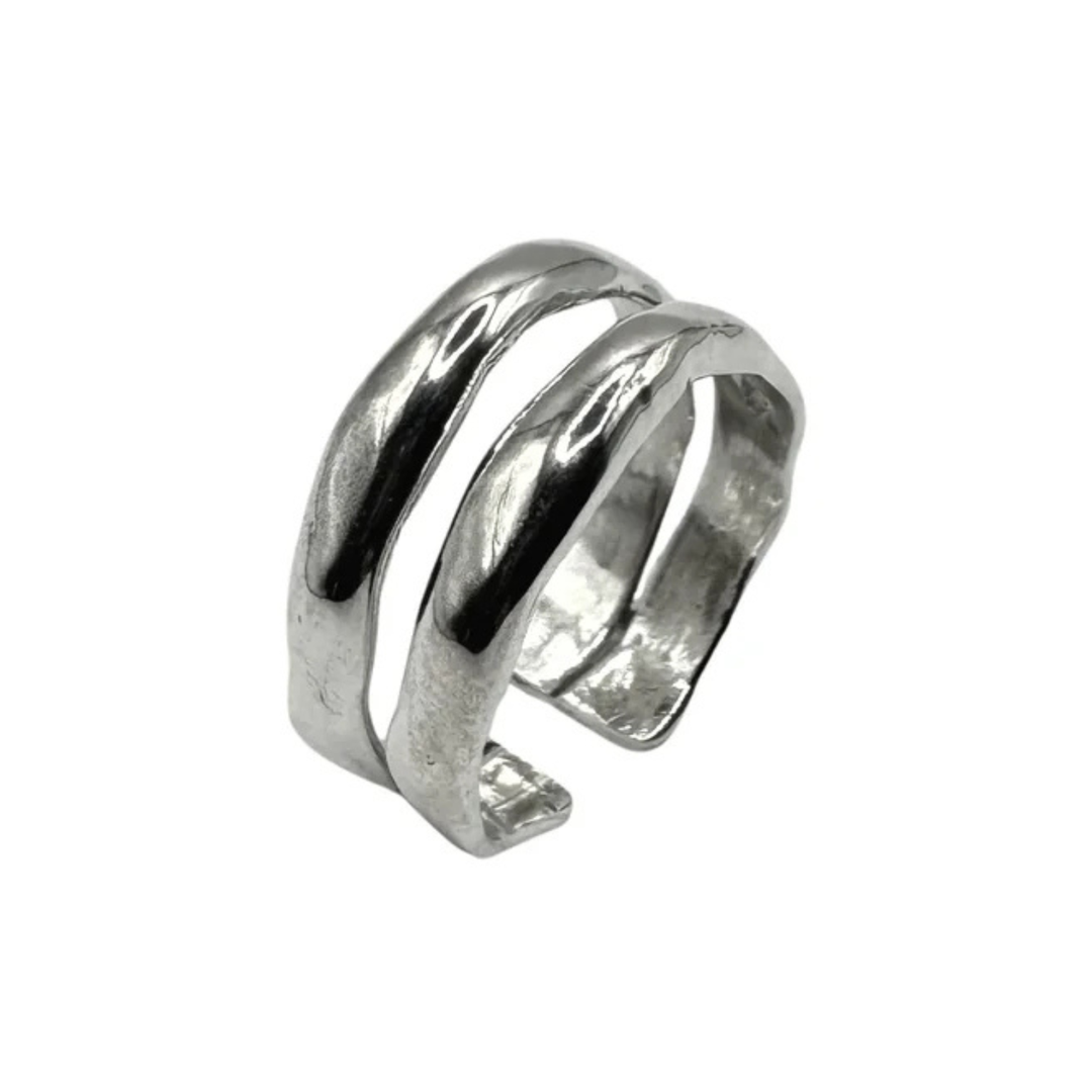 The Duo Silver Ring by Inó Jewellery is a handcrafted, adjustable piece with an open design of two parallel curved bands in polished silver, creating a striking look against a plain white background.