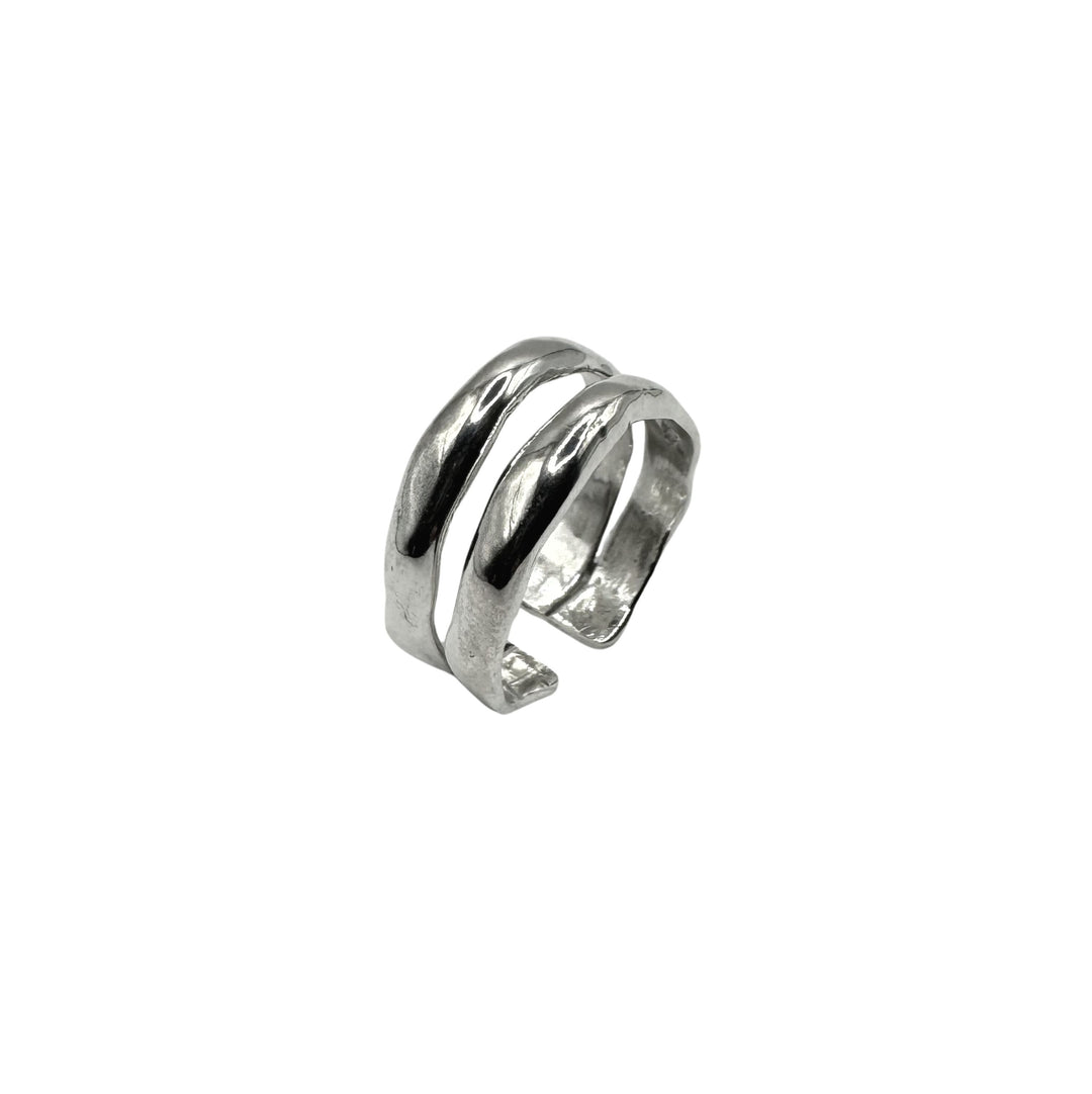 The Duo Silver Ring by Inó Jewellery is a handcrafted, adjustable piece with an open design of two parallel curved bands in polished silver, creating a striking look against a plain white background.