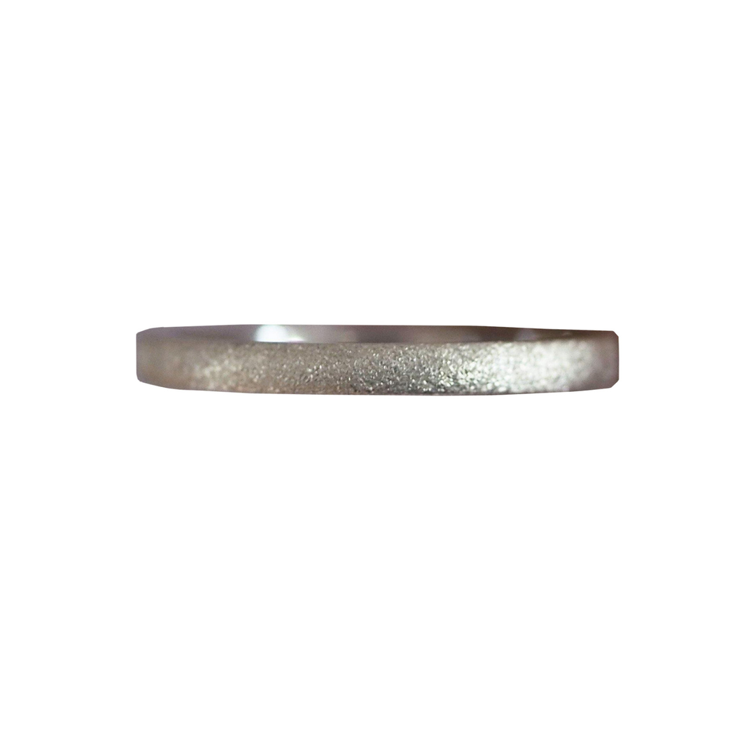The Aud Ellipse Stacking Ring Silver, featuring a thin, flat design with a matte textured finish, is displayed on a white background—ideal for layering.