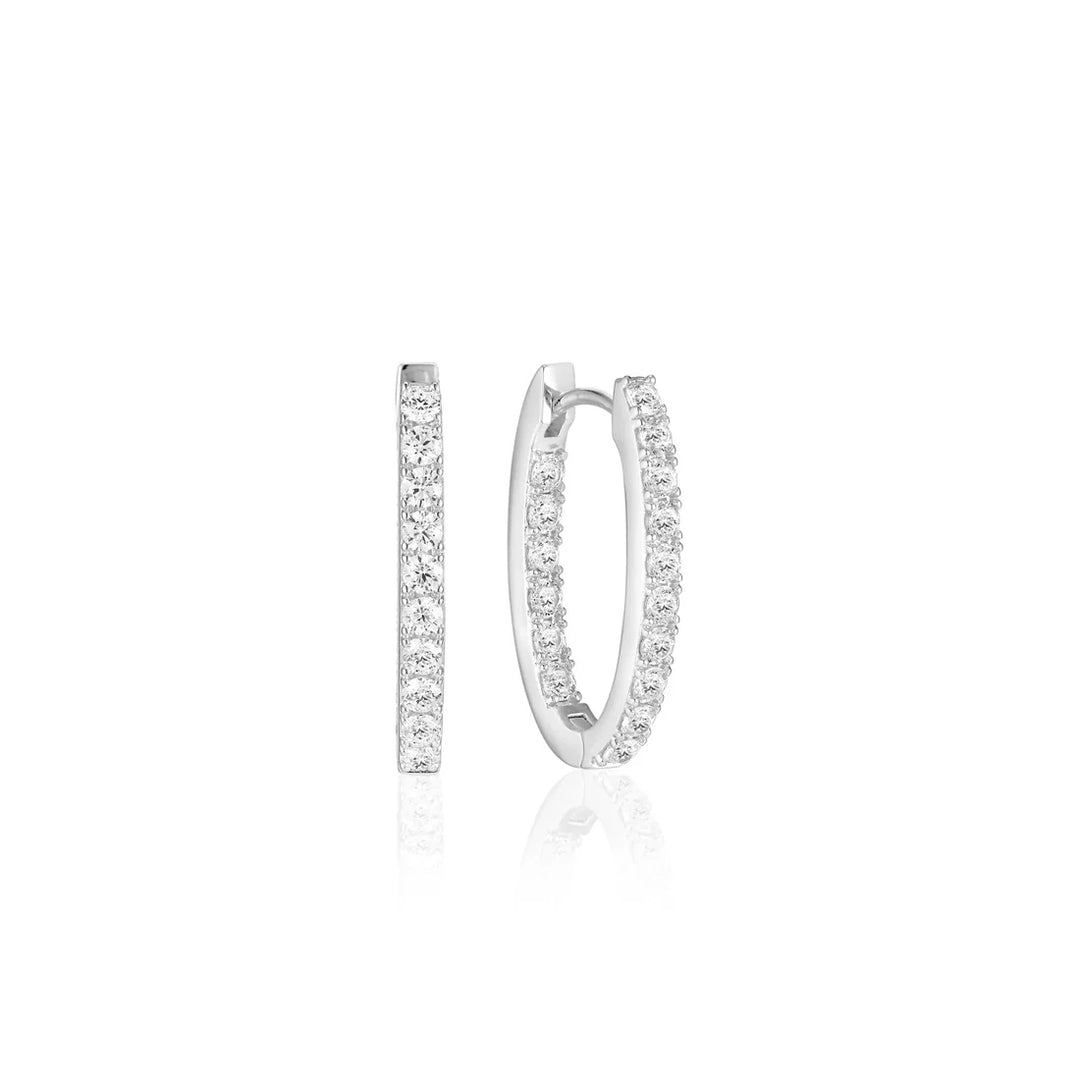 The Sif Jacobs Ellisse Piccolo Oval Hoop Earrings, crafted from 925 sterling silver and adorned with white diamonds, are displayed from the side and front on a white background.