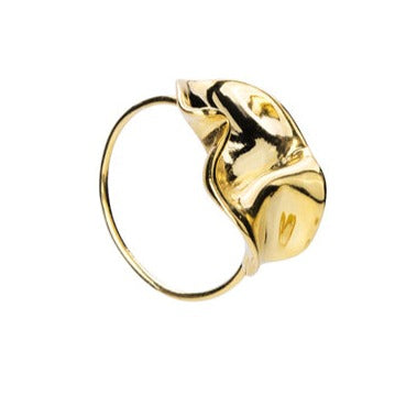 A close-up view of the Bonvo Flor Ring with a unique, abstract, and wavy design on top. The ring features a simple, thin band and an 18ct gold plating with a glossy, polished finish.