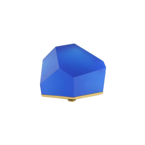 The Fruit Bijoux Ring Top VU Crystals Cobalt Blue by Fruit Bijoux is a geometric, faceted desk decoration or paperweight in vibrant blue with a 24ct gold-plated base. The abstract design resembles a polygonal gem or crystal.