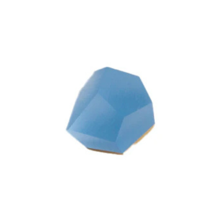 A single, faceted, irregularly-shaped blue gem or crystal with an angular, multi-faceted surface. This striking Fruit Bijoux Ring Top VU Crystals Sky Blue by Fruit Bijoux is set atop a sterling silver ring and is placed against a plain, white background.